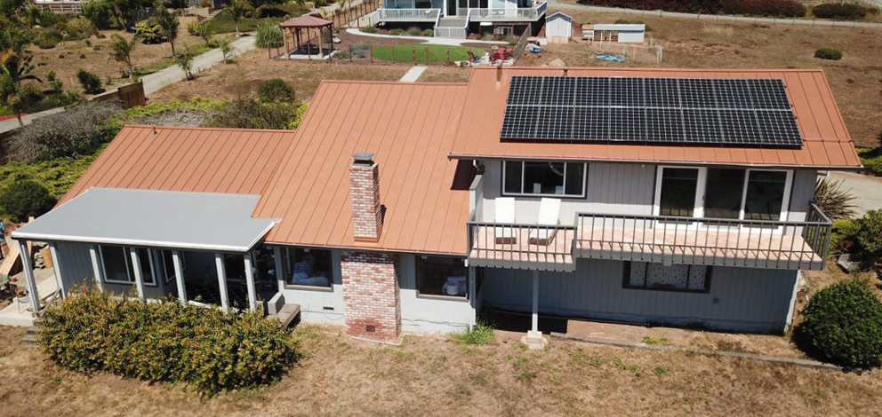 Aerial view of residential home featuring our Copper Penny Skyline panels with solar panels installed. 