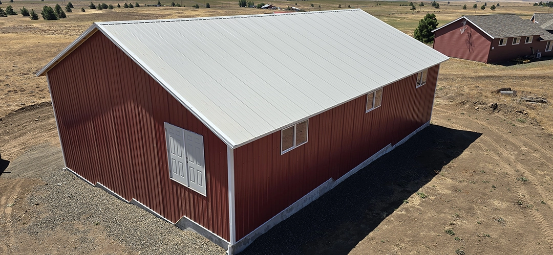 This Nor-Clad® Barn in Goldendale, WA uses ASC Building Products' Rustic Red for siding, Desert Beige for roofing and Winter White for the trim.