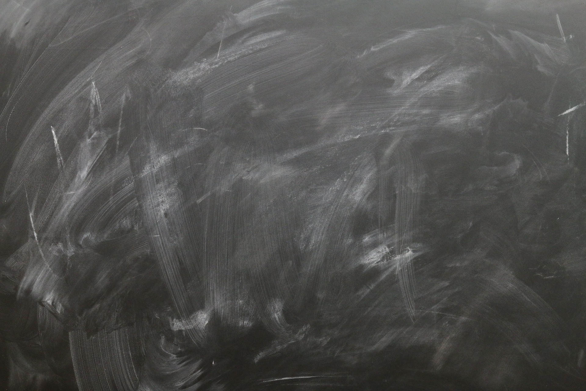 A blackboard covered in white chalk.